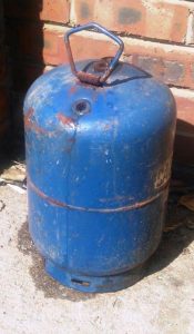 A scrapped, old, leaking gas cylinder to be used as a burn chamber in the rocket stove upgrade part two